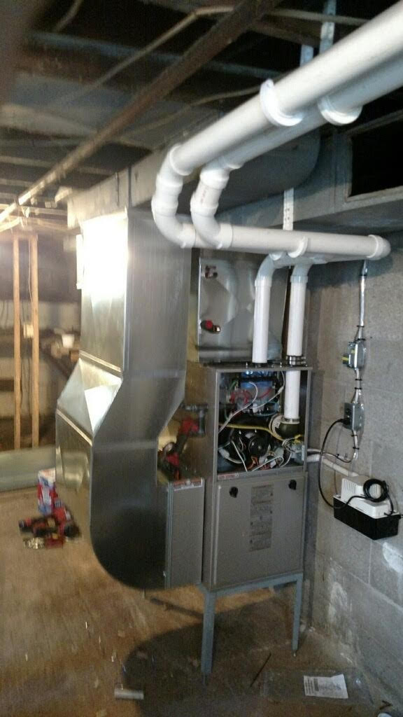 Grey metal furnace with exposed wiring